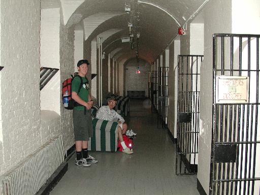 the corridor outside our cell, random inmate on the left, Joe relaxing in the chair.