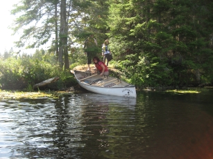 Portage of a canoe at Hailstorm Creek
